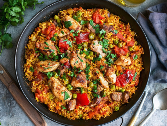 Image of a pan of paella with chicken and pork, which pairs perfectly with Croma Vera Wines Cabernet Sauvignon. Taste Croma Vera's wines at our tasting room in San Luis Obispo, CA.